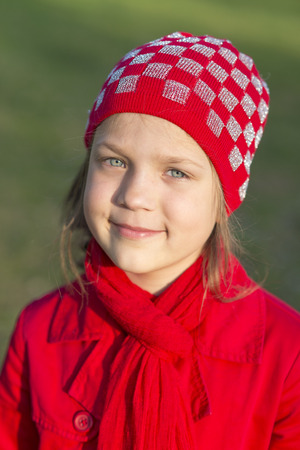 headshot of smiling girl in red clothes by springtime eveningの写真素材