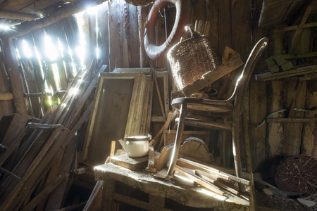 old wooden abandoned barn interior with bright sun beams fallen through cracks in the wallの写真素材