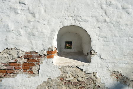 fragment of ancient fortification brick wall painted by white in Yaroslavl,Russiaの写真素材