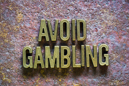 avoid gambling phrase made from metallic letters over rusty metallic backgroundの写真素材