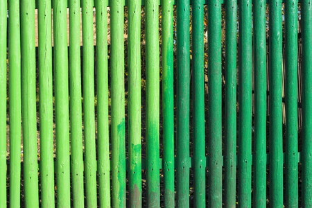 wooden fence fragment painted by different kind of green paintの写真素材