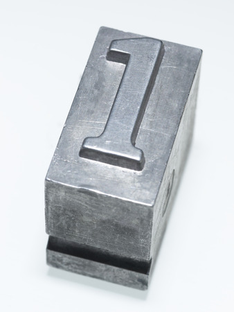 detailed number one sign metallic letterpress type block isolated on whiteの写真素材