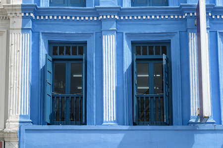 blue painted windows with open shutters in Singapore Chinatown