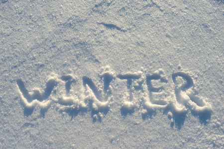 winter word handwritten on pure snow surface outdoorの写真素材