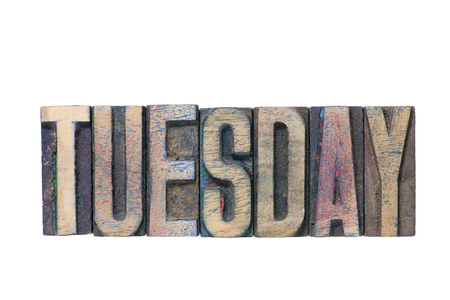Tuesday word made from mixed wooden letterpress type isolated on whiteの写真素材