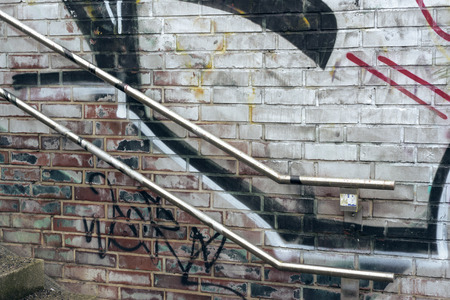 urban  painted wall near stairway with metallic handrailsの写真素材