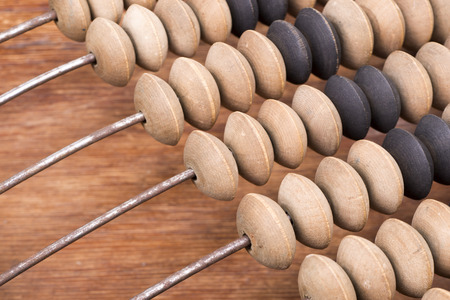 tilted vintage wooden abacus fragment with focus on beadsの写真素材
