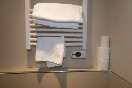 bathroom heater with two white towelsの写真素材