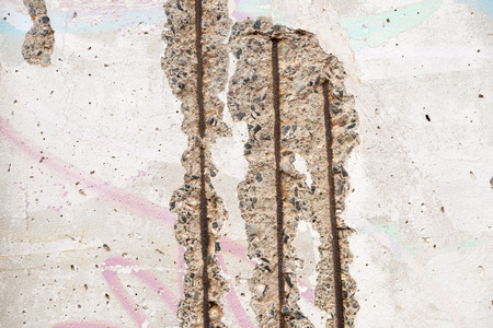 closeup fragment of famous Berlin wall ruins with open rusty carcass
