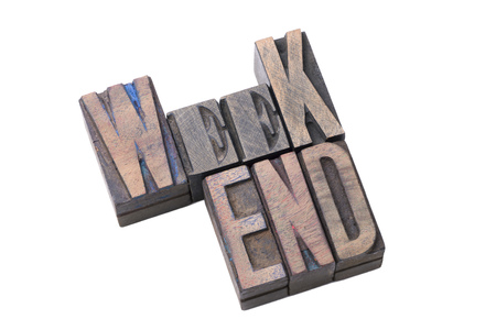tilted weekend word made from vintage wooden letterpress type isolated on whiteの写真素材