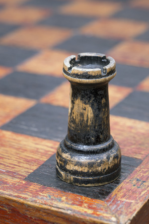 vintage wooden rook piece on the chessboardの写真素材