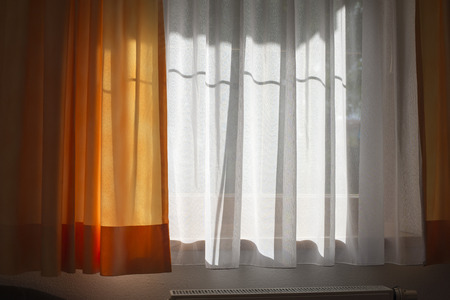 home curtains interior with bright sunlight behind the window