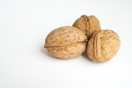 three walnuts isolated on white backgroundの写真素材