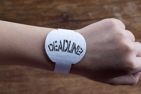 hand with handmade  paper watches and deadline exclamation printの写真素材