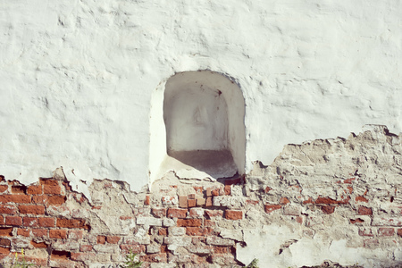 ancient weathered brick wall with walled loopholeの写真素材