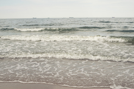 Baltic sea sand beach with quiet surf in Gdansk, Poland