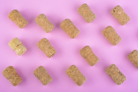 many champagne corks on pink backgroundの写真素材