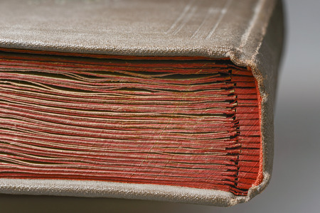 bookbinder fragment of vintage album with red carton pagesの写真素材