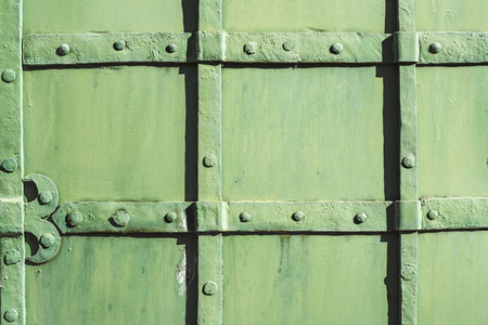 fragment of ancient metallic door painted by greenの写真素材