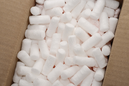 fragment of carton box  with white packing foam filling inside