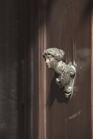 massive bronze handle from ancient wooden door in Venice, italyの写真素材