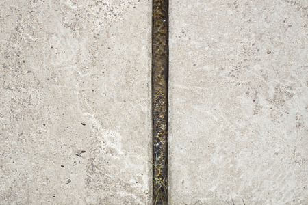 narrow water channel between two huge concrete tilesの写真素材