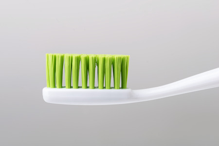 clean white green toothbrush isolated close up image