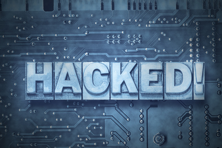 hacked exclamation made from metallic letterpress blocks on the pc board backgroundの写真素材