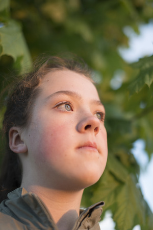 girl portrait closeup outdoors by evening with focus on eyesの写真素材