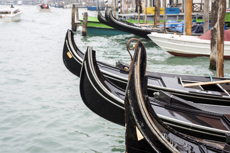 Venetian gondolas rows on Grand Canal watersの写真素材