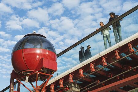 VENICE - OCTOBER 17: people looking at futuristic lift cabin located near pedestrian bridge in...