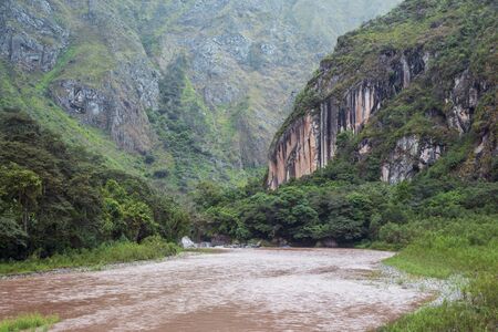 powerful Urubamba river stream by rainy day in Peru の写真素材