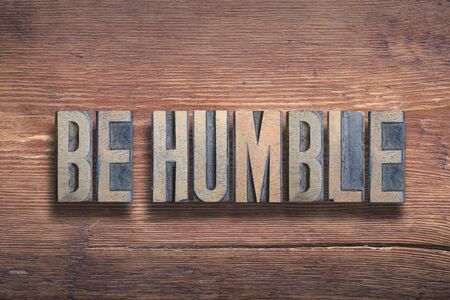 be humble phrase combined on vintage varnished wooden surfaceの写真素材