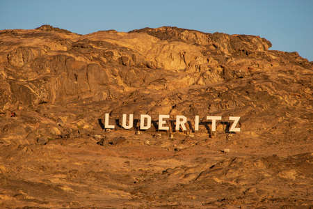 Luderitz town sign on the mountain wall in Namibia