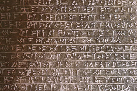 detailed background of ancient assyrian cuneiform stone carving