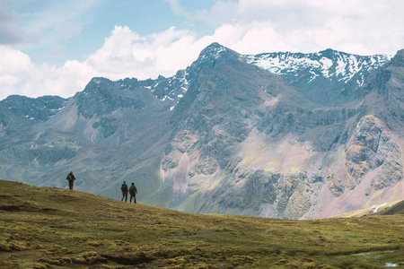 mountain landscape with three hikers on slope in Peruvian Andesの写真素材