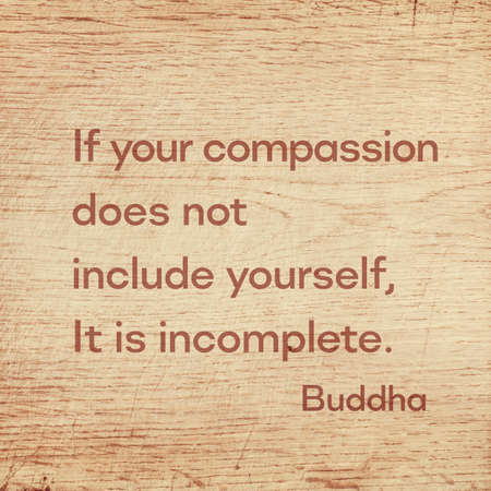 If your compassion does not include yourself, It is incomplete - famous quote of Gautama Buddha printed on grunge wooden boardの写真素材