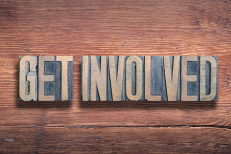 get involved phrase combined on vintage varnished wooden surfaceの写真素材