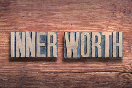 inner worth phrase combined on vintage varnished wooden surfaceの写真素材