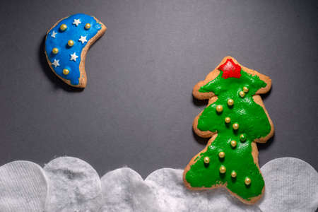 simple Christmas scenery made from decorated cookies on gray backgroundの写真素材