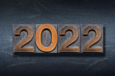 numbers 2022 made from wooden letterpress on dark jeans backgroundの写真素材