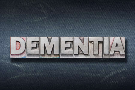 dementia word made from metallic letterpress on dark jeans backgroundの写真素材