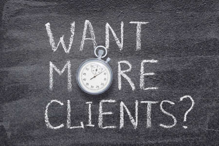 want more clients question written on chalkboard with vintage precise stopwatchの写真素材