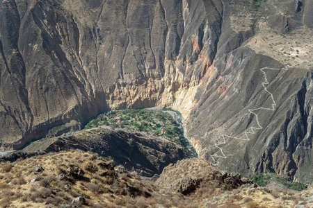 green oasis at the bottom of Colca river canyon in Peruの写真素材