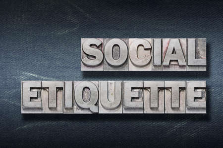 social etiquette phrase made from metallic letterpress on dark jeans backgroundの写真素材