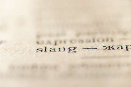 focus on slang word printed inside vintage vocabularyの写真素材