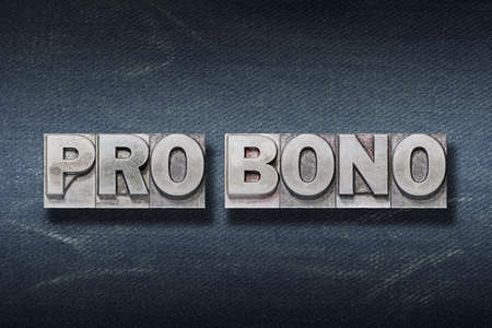 pro bono (for the public good) Latin phrase made from metallic letterpress on dark jeans backgroundの写真素材