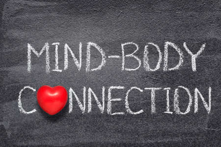 mind-body connection phrase written on chalkboard with red heart symbolの写真素材