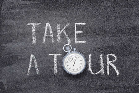 take a tour phrase written on chalkboard with vintage precise stopwatchの写真素材