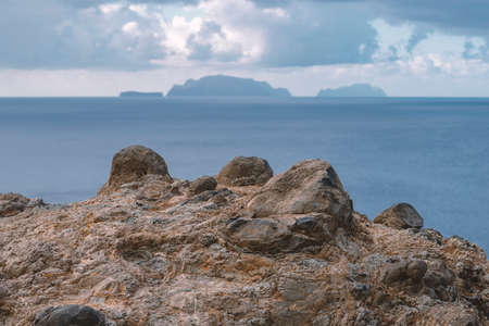 Madeira Islands Archipelago by cloudy day with focus on frozen lava shore on foregroundの写真素材